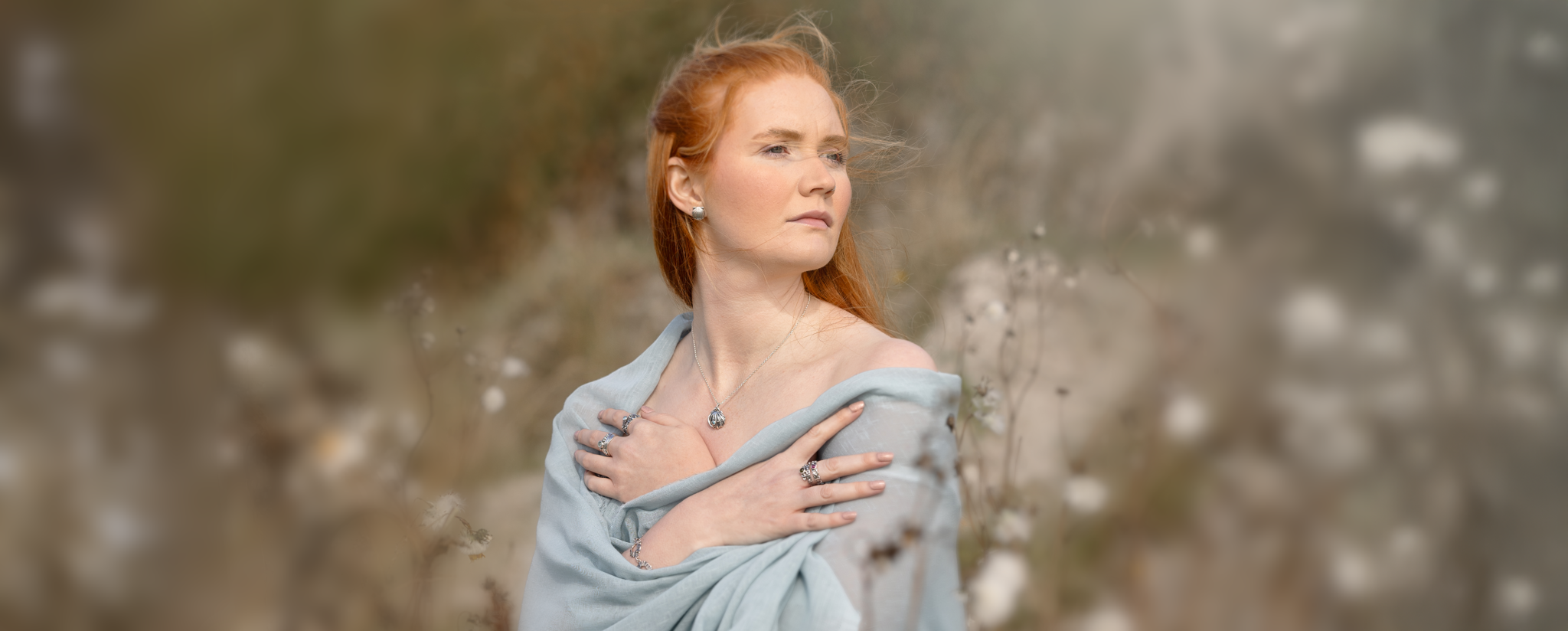 Photograph of a red haired woman wearing Marion's jewellery.